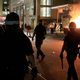 New York Police Department officers walk past a dumpster fire in front of the Hampton Inn on West 35th Street during a rally in response to the death of George Floyd while in Minneapolis police custody on May 31, 2020 in New York City.